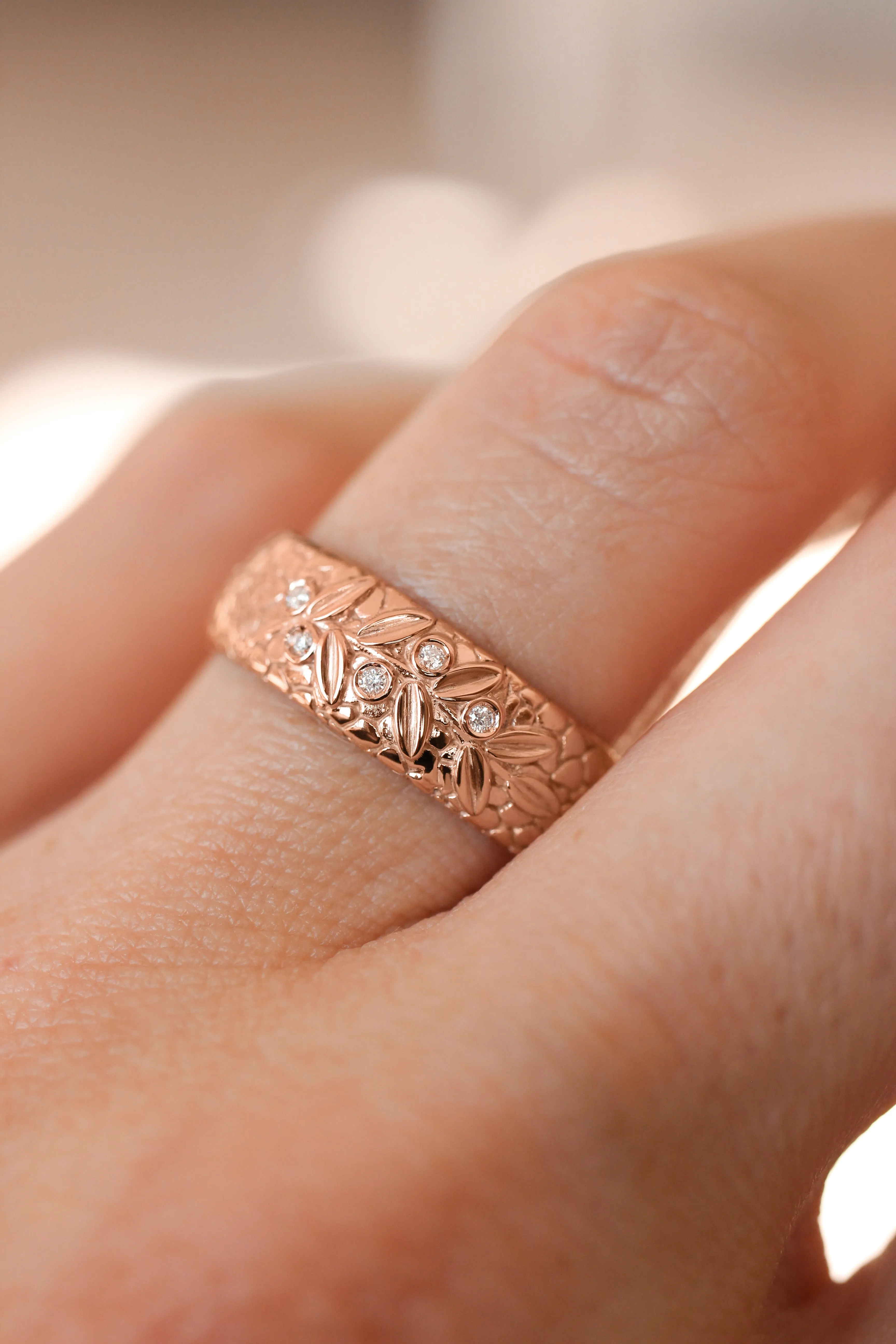 Textured wedding band with olive branch and diamonds