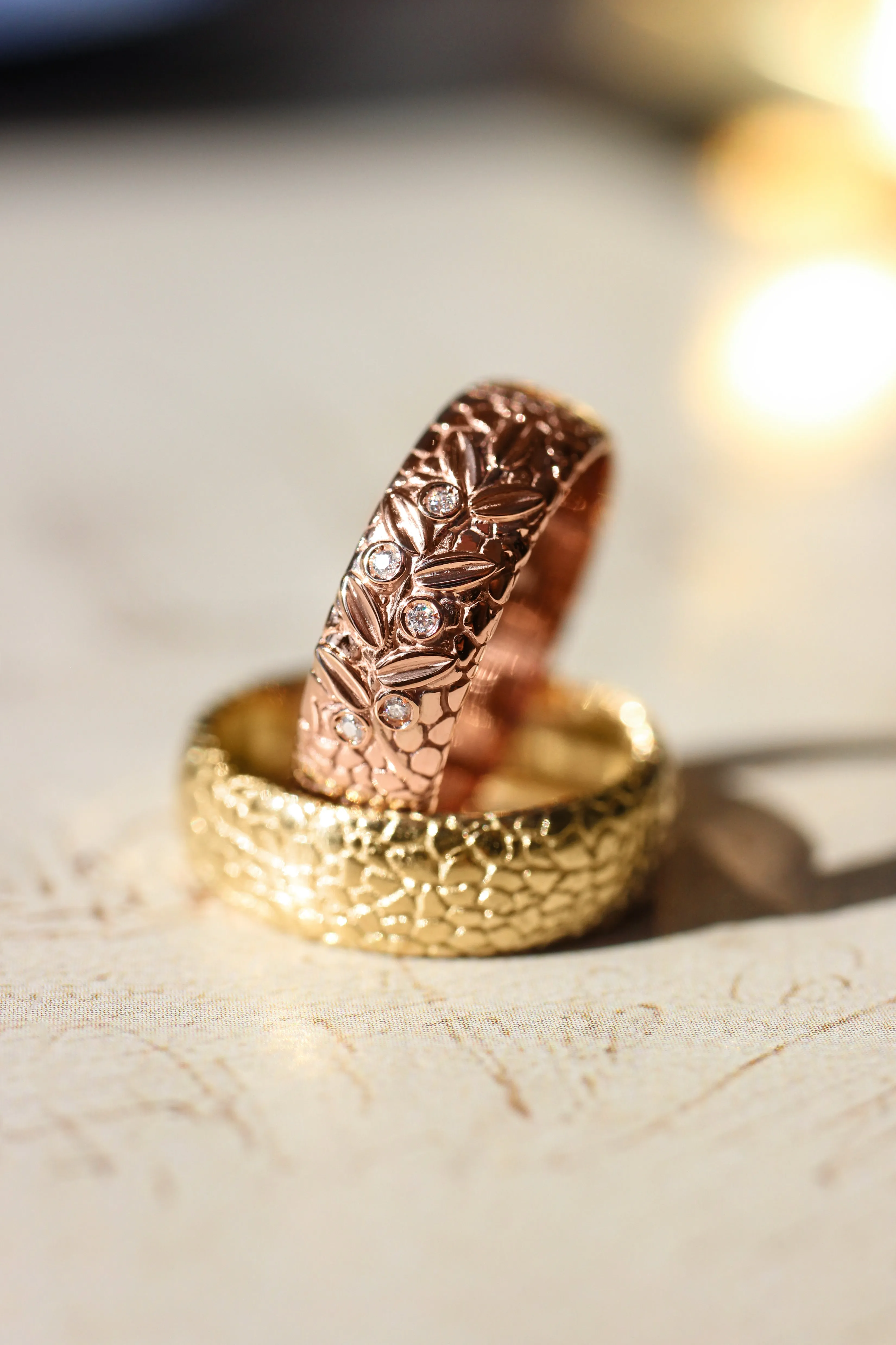 Textured wedding band with olive branch and diamonds