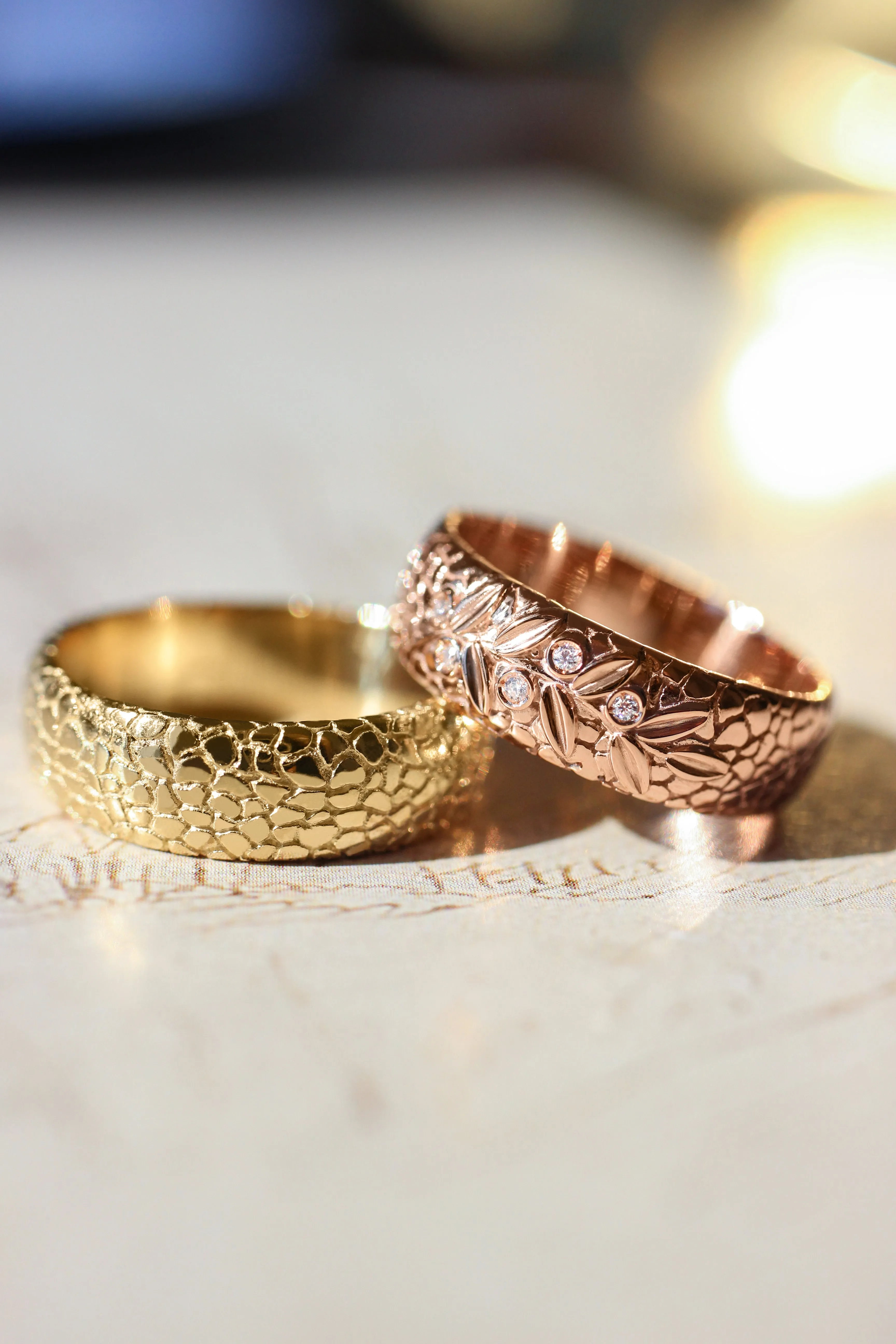 Textured wedding band with olive branch and diamonds