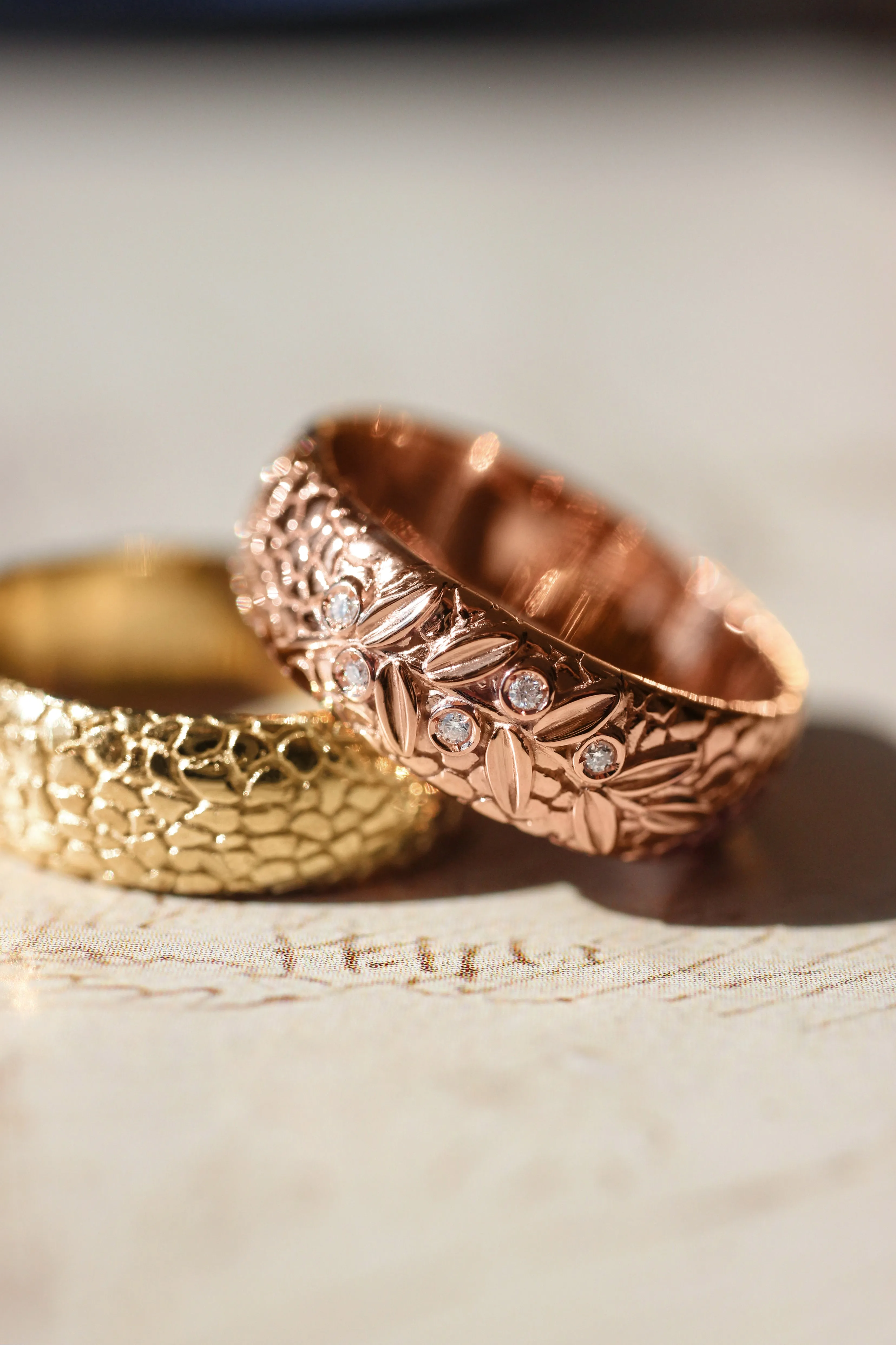 Textured wedding band with olive branch and diamonds