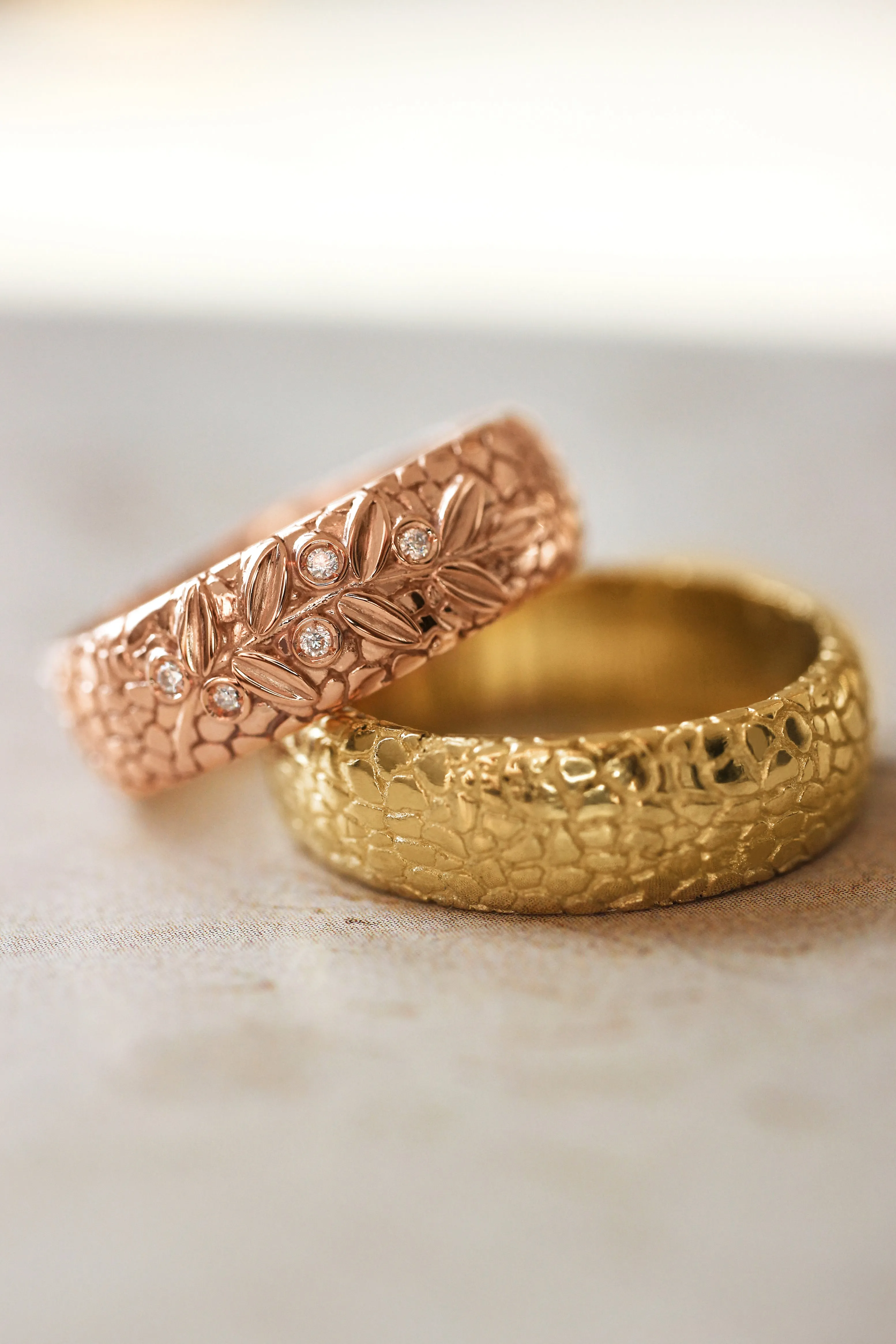 Textured wedding band with olive branch and diamonds